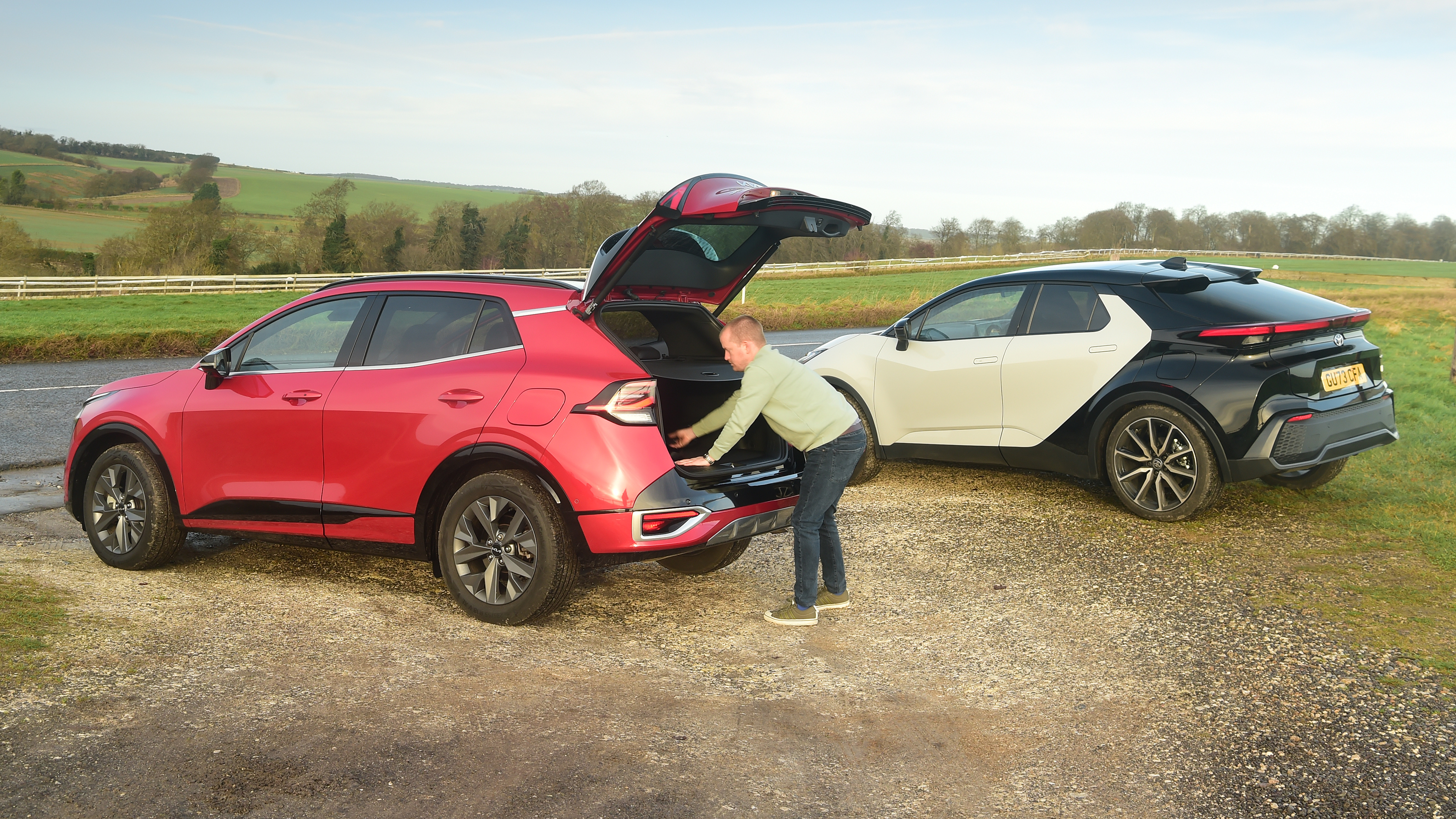 Auto Express chief reviewer Alex Ingram loading the Kia Sportage's boot
