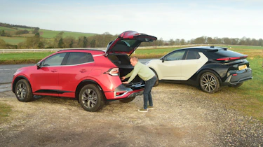 Auto Express chief reviewer Alex Ingram loading the Kia Sportage's boot