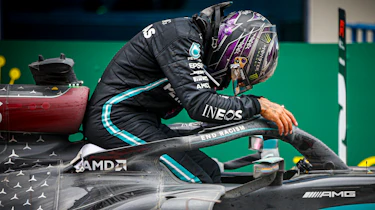 Lewis Hamilton climbing into F1 car