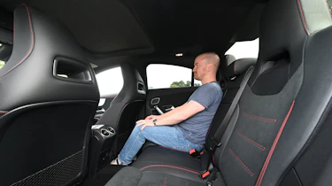 Auto Express chief reviewer Alex Ingram sitting in the Mercedes CLA's back seat
