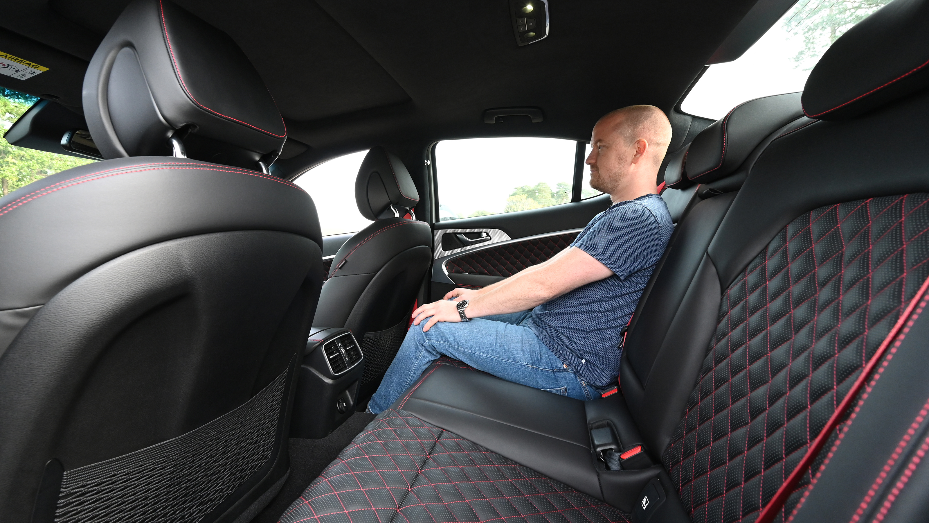 Genesis G70 - Auto Express chief reviewer Alex Ingram sitting in the Genesis G70's back seat