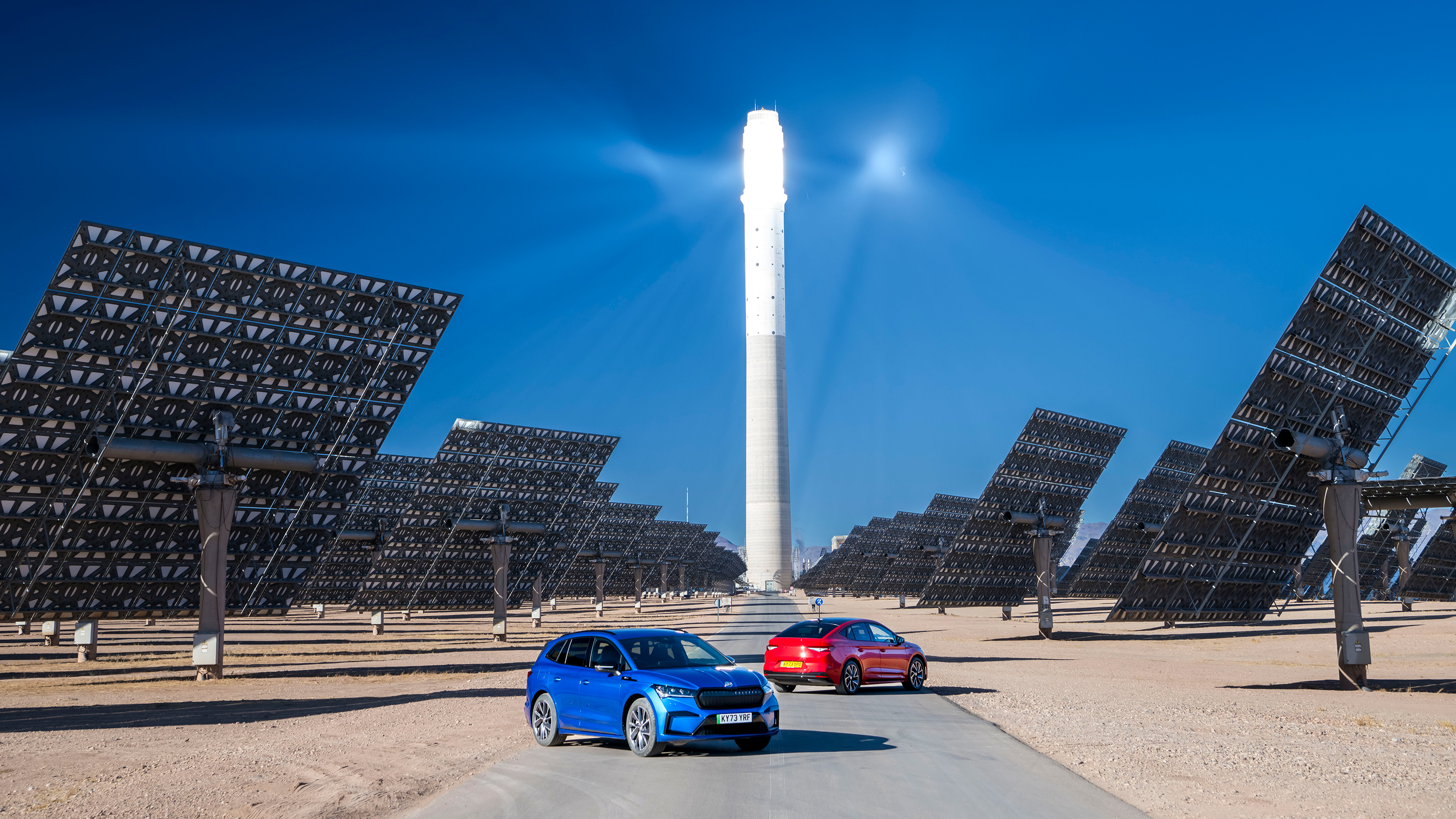 Skoda Enyaq and Enyaq Coupe parked in front of Noor Tower