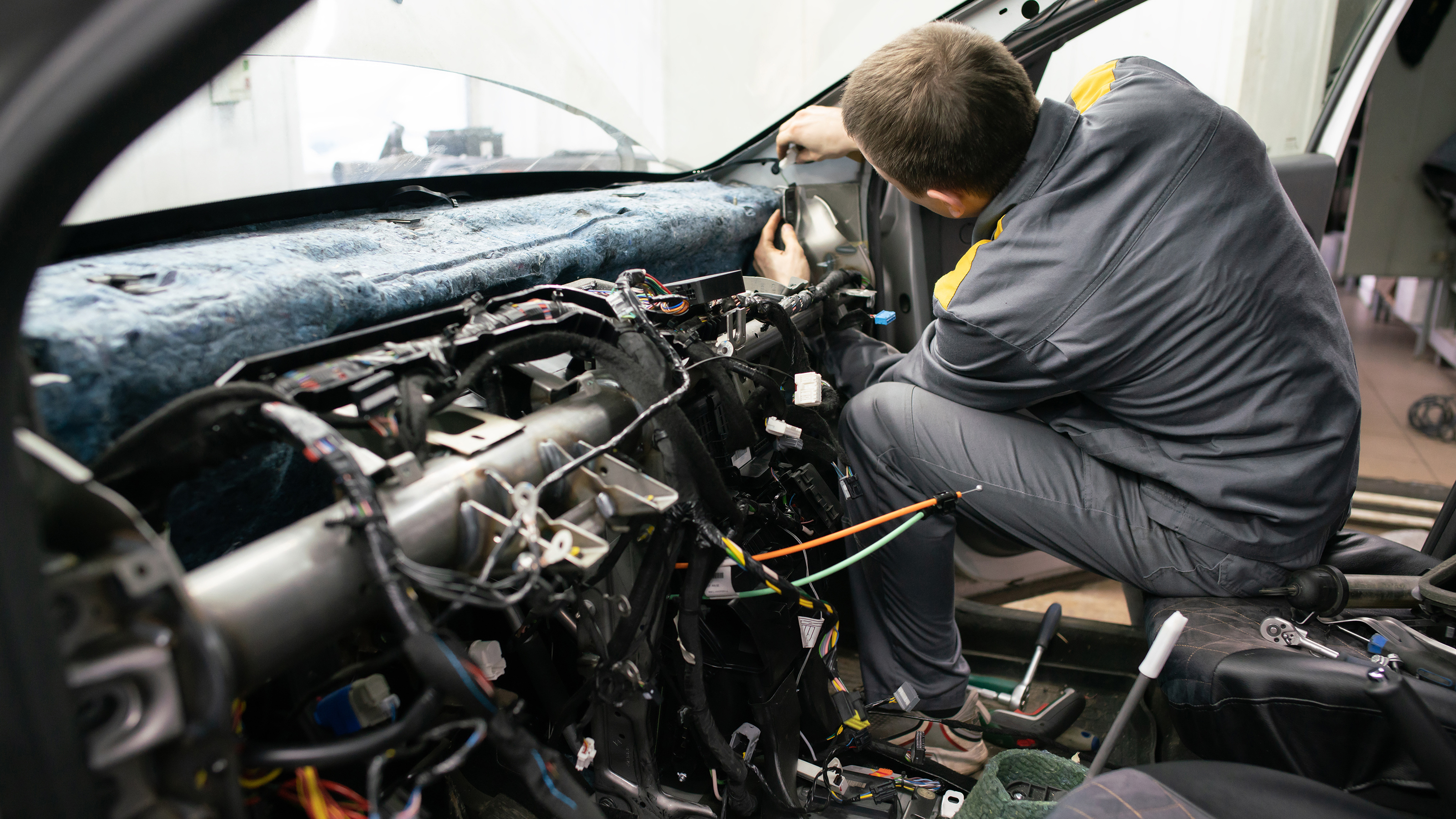 Technician working on dashboard wiring