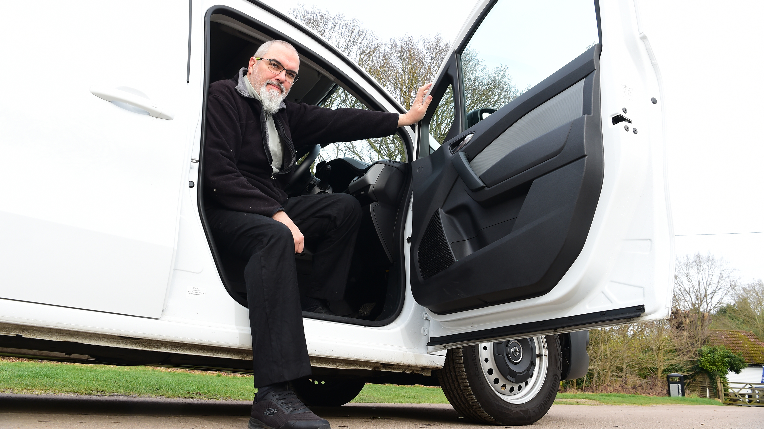 Auto Express senior road test editor Dean Gibson leaning out of the Renault Kangoo's driver's door