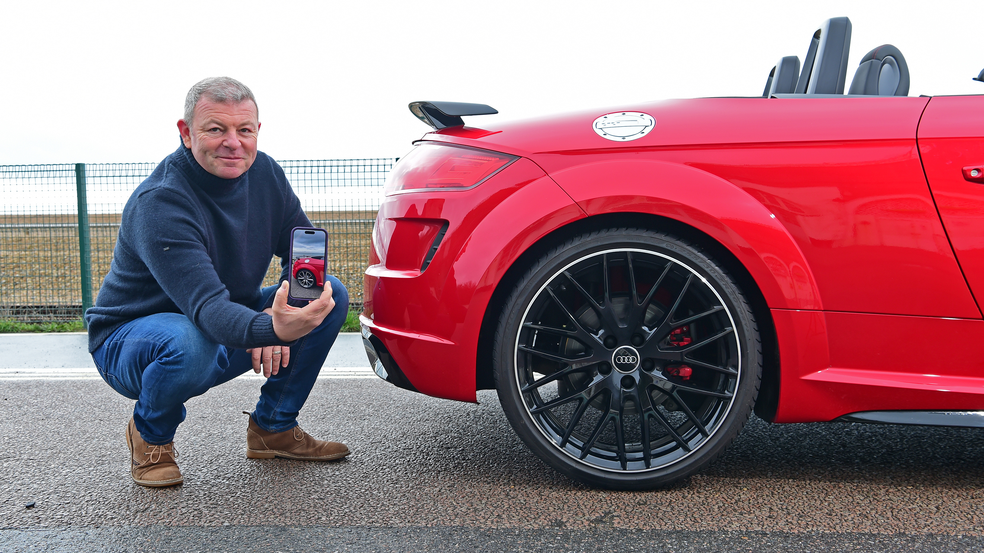 Auto Express contributing editor Steve Sutcliffe potining at the Audi TT Roadster Final Edition's rear bumper