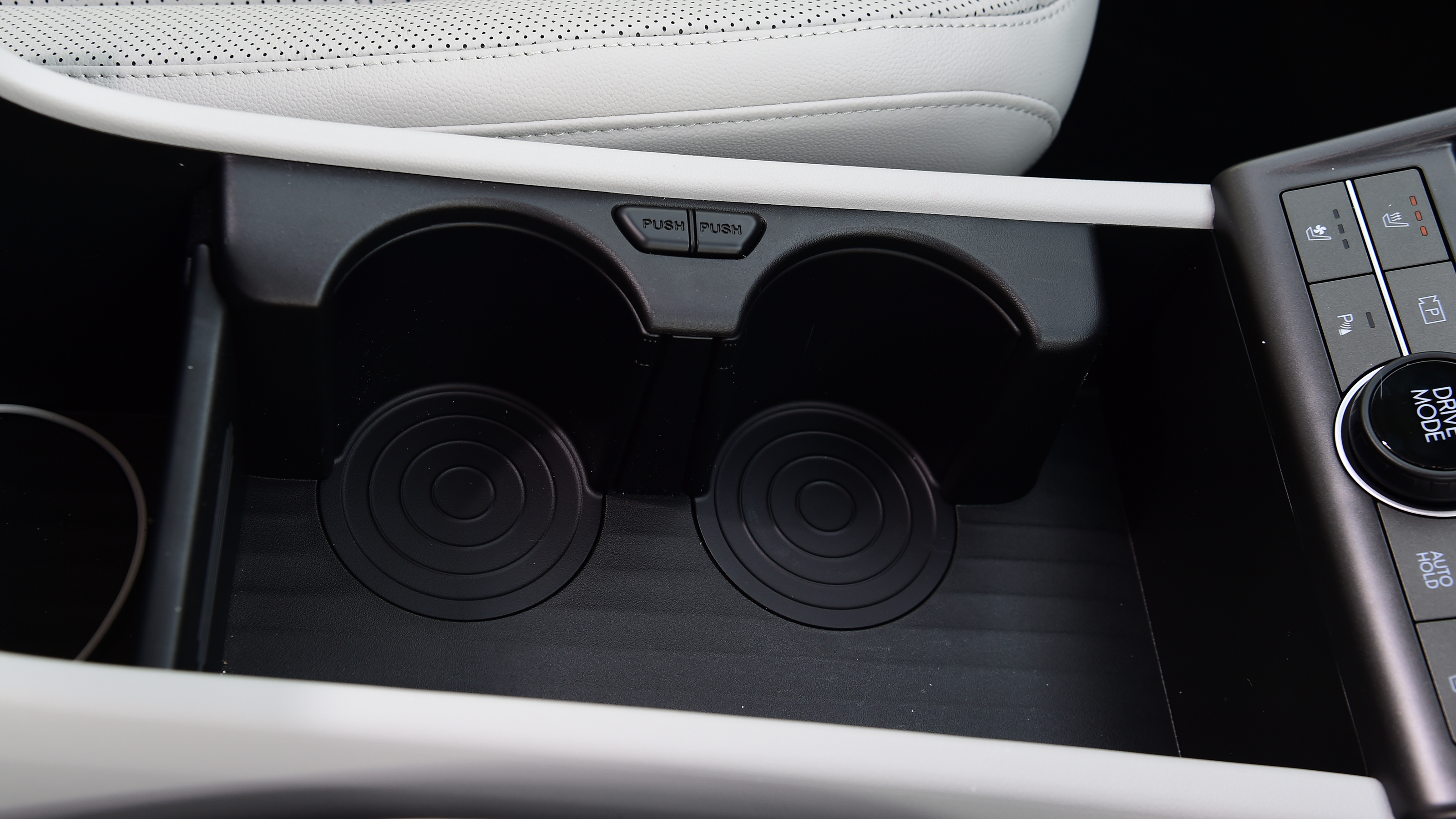 Honda e:Ny1 vs Hyundai Kona Electric - Hyundai Kona Electric front cupholders 