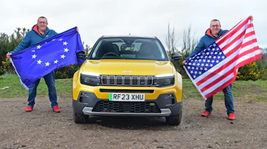 Auto Express editor-at-large John McIlroy holding an EU and US flag while standing next to the Jeep Avenger