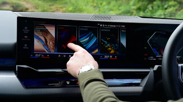 Auto Express chief reviewer operating the BMW 530e's infotainment sytem