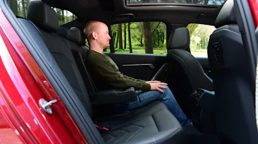 Auto Express chief reviewer Alex Ingram sitting in the BMW 530e's back seat