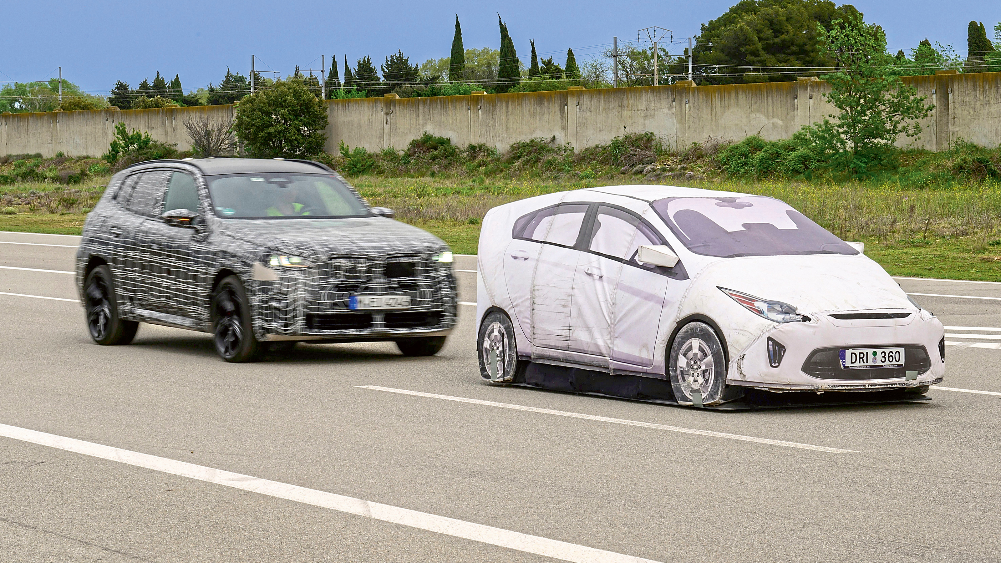BMW X3 prototype (camouflaged) and dummy test car - front