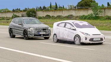 BMW X3 prototype (camouflaged) and dummy test car - front