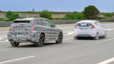BMW X3 prototype (camouflaged) and dummy test car - front