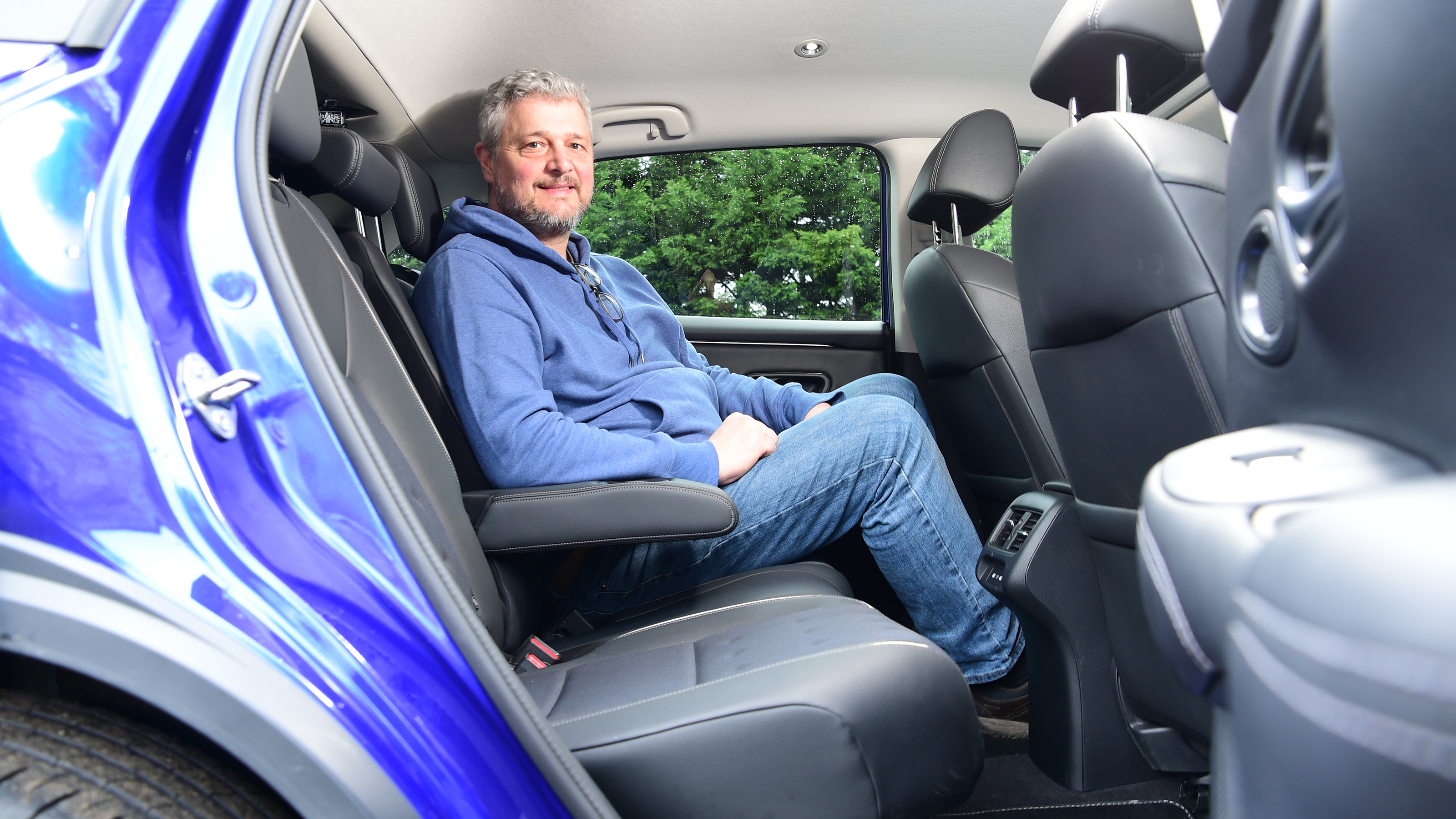 Auto Express current affairs and features editor Chris Rosamond sitting in the Honda ZR-V's back seat
