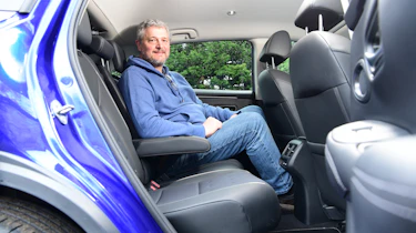 Auto Express current affairs and features editor Chris Rosamond sitting in the Honda ZR-V's back seat