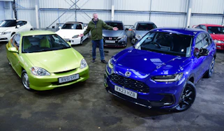 Auto Express current affairs and features editor Chris Rosamond standing between a Mk1 Honda Insight and a Honda ZR-V