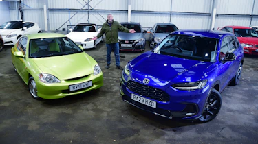 Auto Express current affairs and features editor Chris Rosamond standing between a Mk1 Honda Insight and a Honda ZR-V