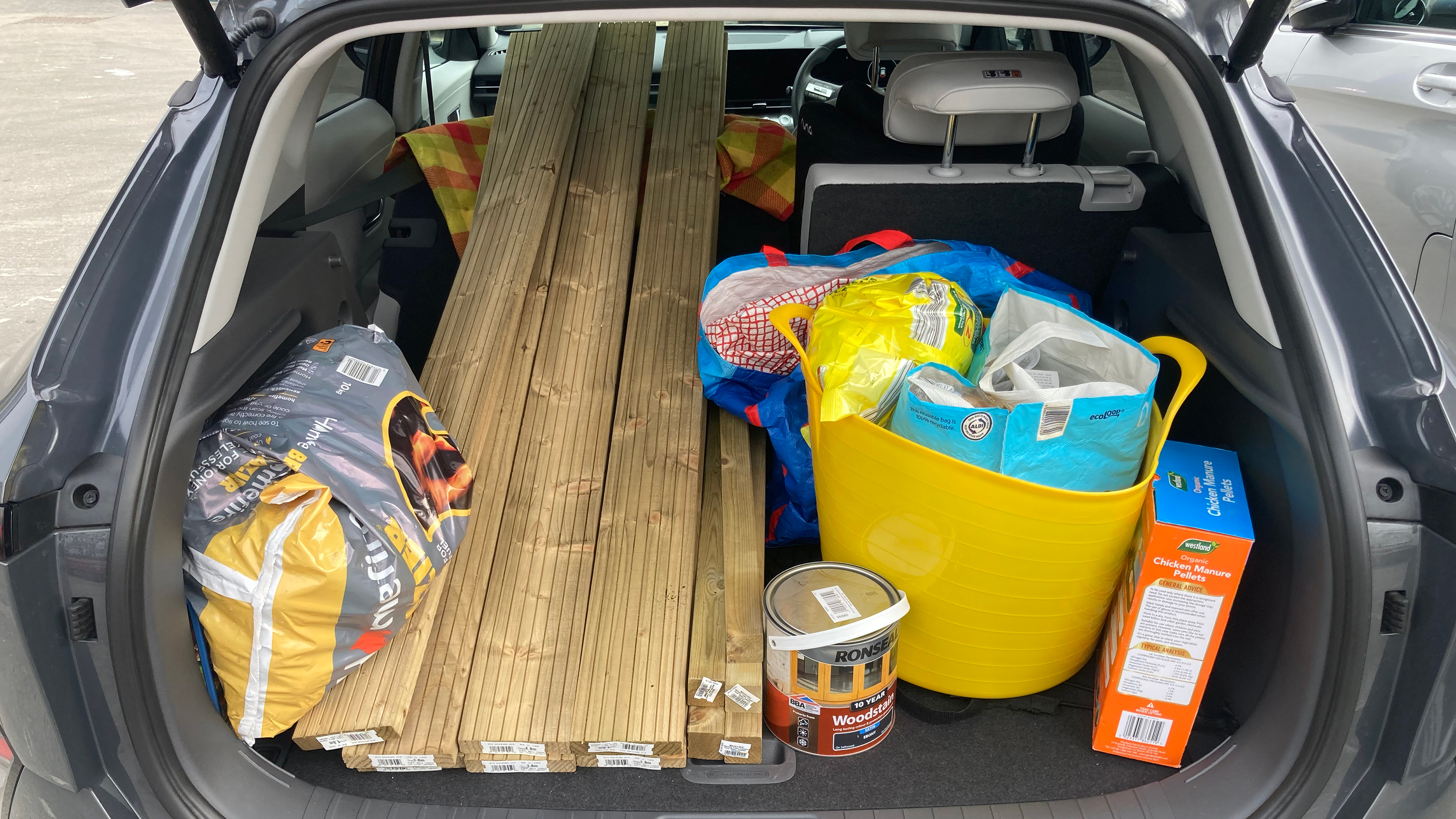 Hyundai Kona Electric boot full of garden equipment