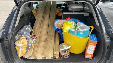 Hyundai Kona Electric boot full of garden equipment