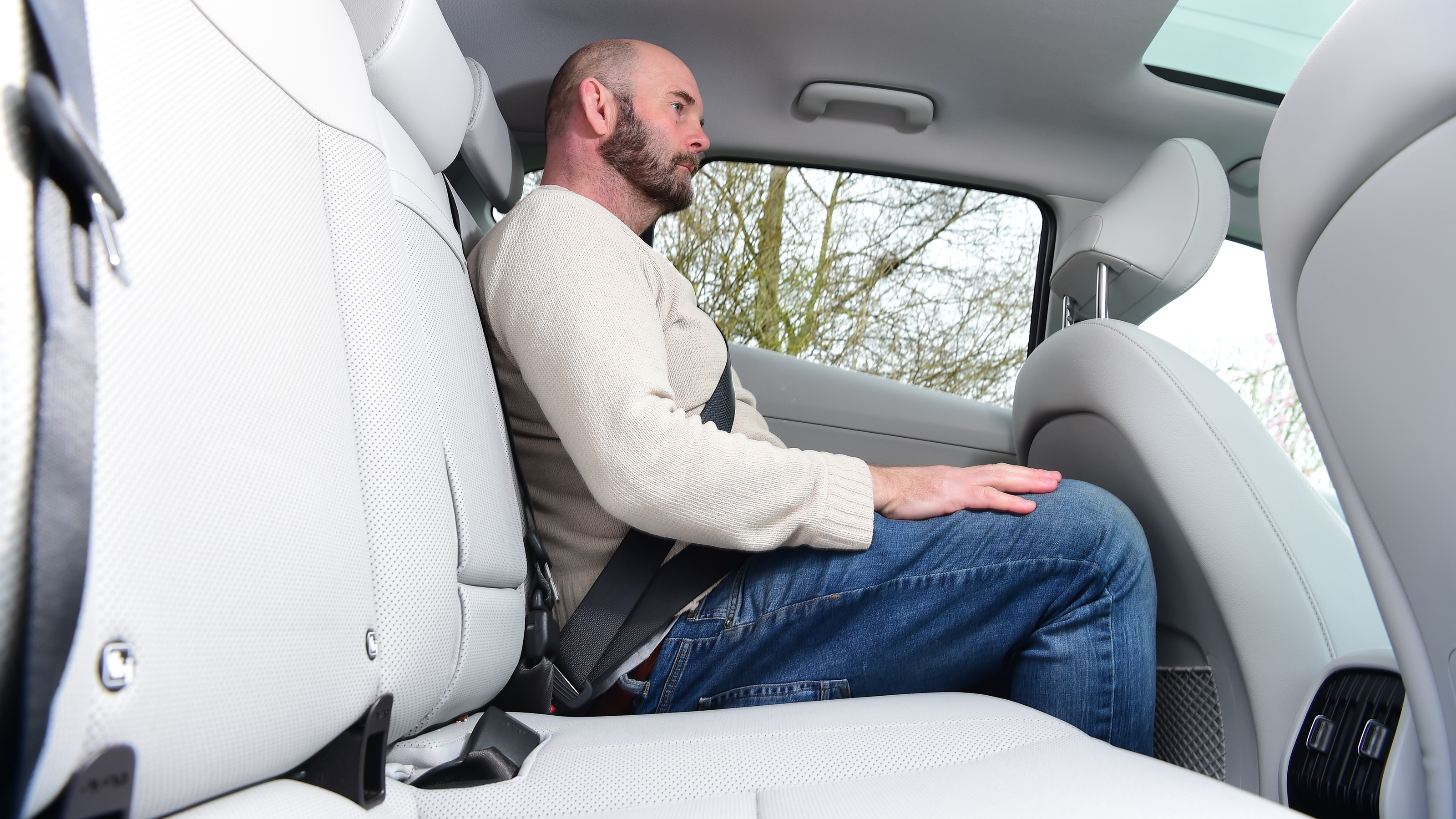 Auto Express creative director Darren Wilson sitting in the back of the Hyundai Kona Electric
