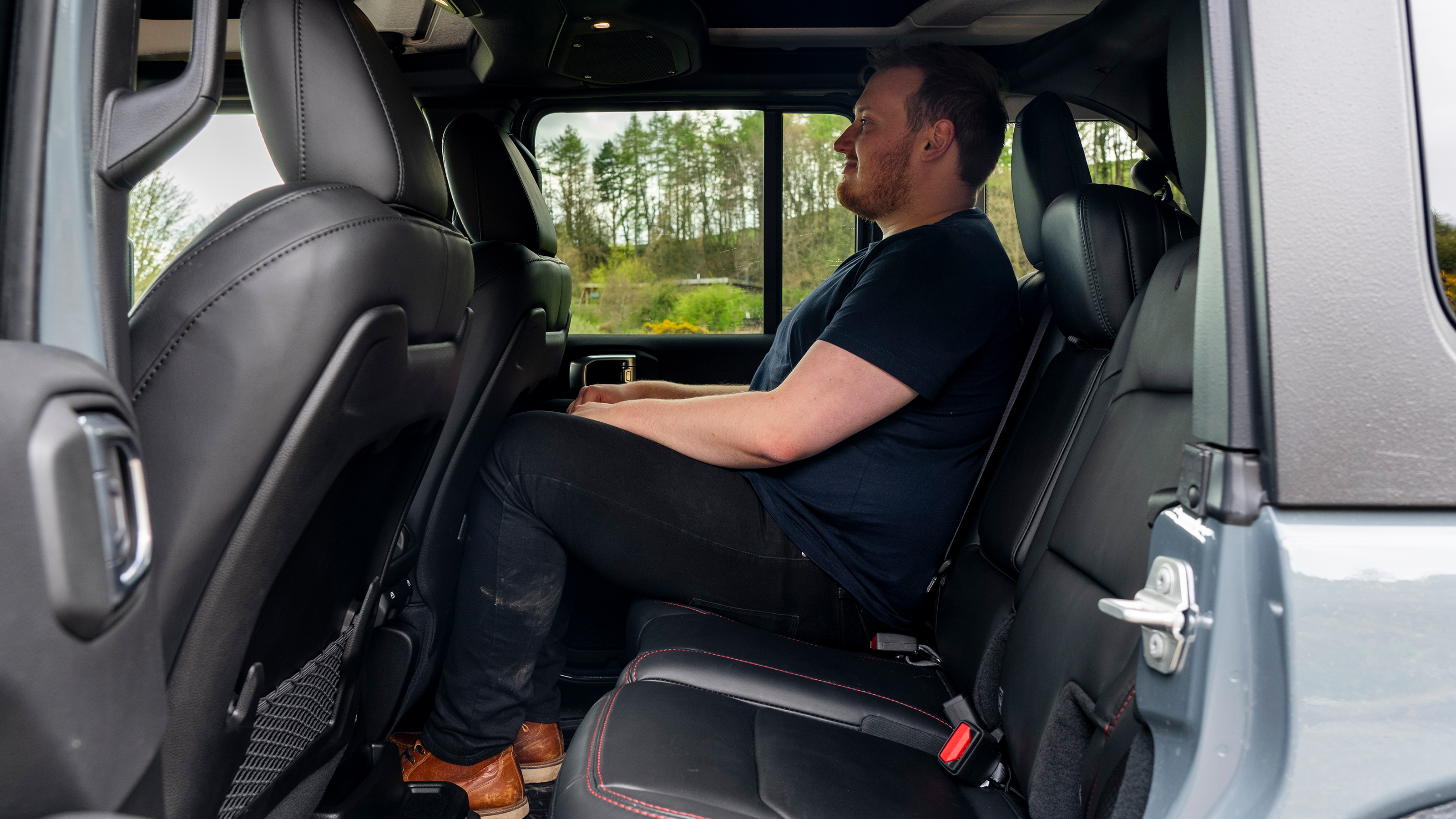 Auto Express news reporter Ellis Hyde sitting in the Jeep Wrangler Rubicon's back seat