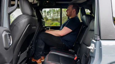 Auto Express news reporter Ellis Hyde sitting in the Jeep Wrangler Rubicon's back seat
