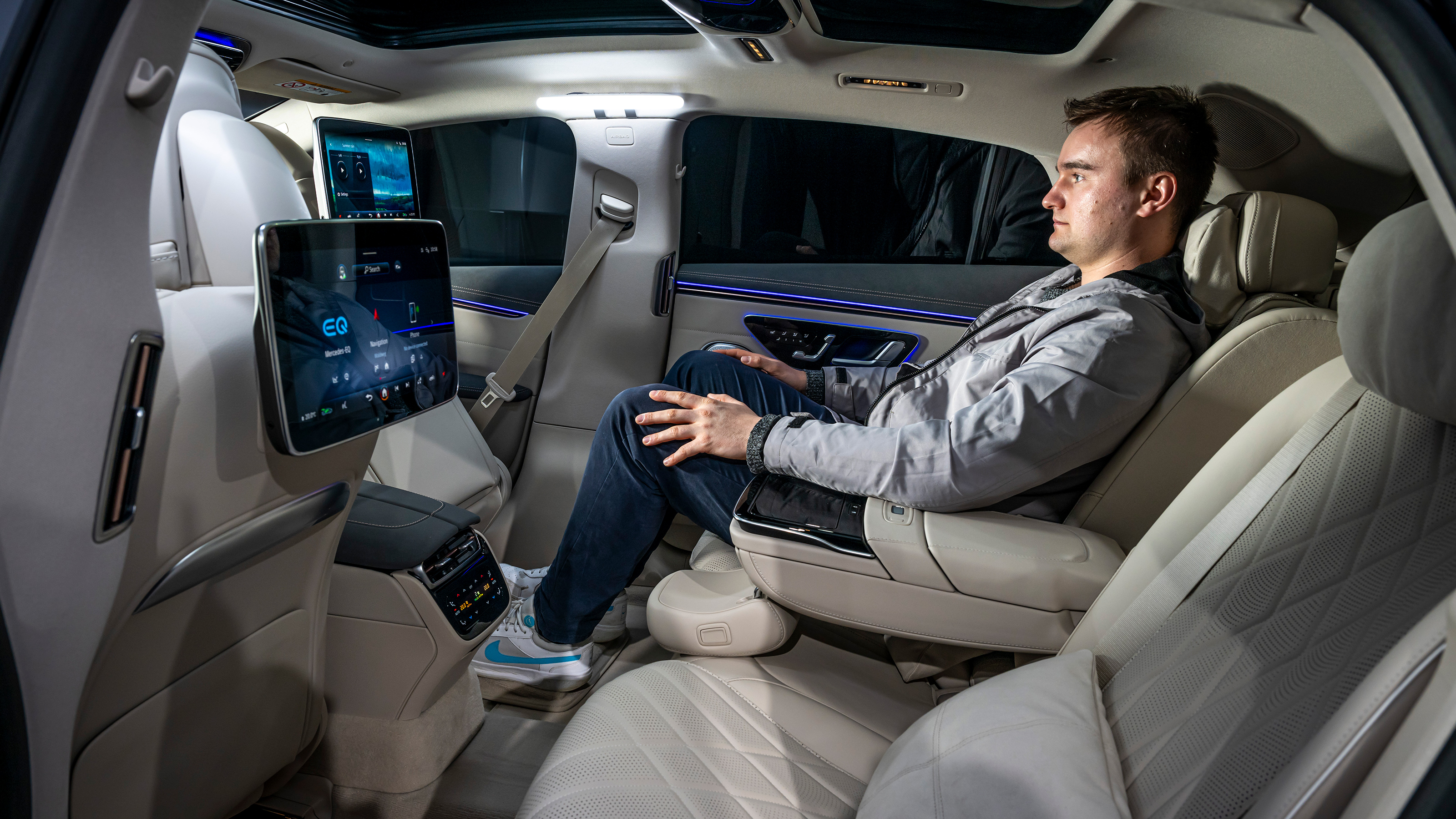 Auto Express senior news reporter Alastair Crooks sitting in the Mercedes EQS's back seat