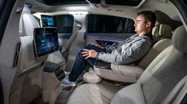 Auto Express senior news reporter Alastair Crooks sitting in the Mercedes EQS's back seat