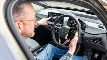 Auto Express chief sub editor Andy Pringle using a phone stopwatch app while sitting in the Volkswagen ID.3