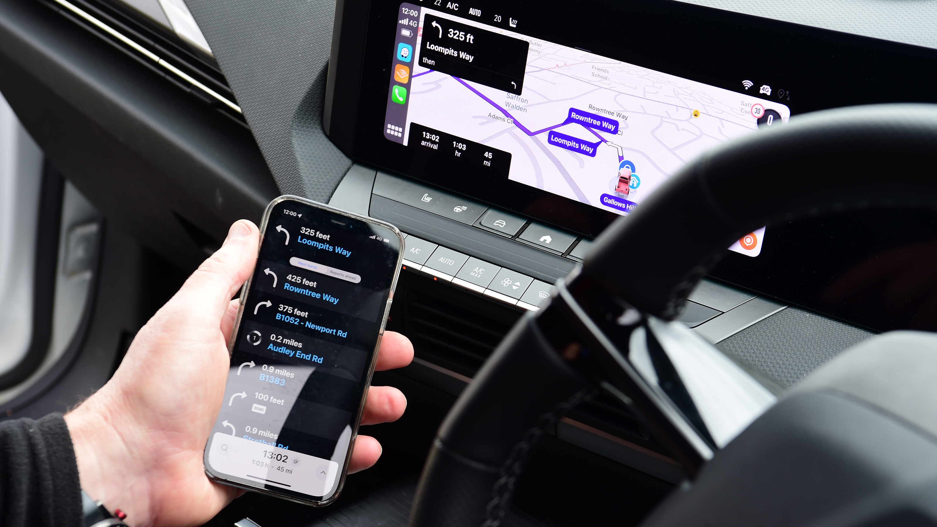 Auto Express products editor Kim Adams connecting a smartphone to the Vauxhall Astra GSe's infotainment system
