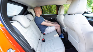 Auto Express chief reviewer Alex Ingram sitting in the Fiat 600e's back seat