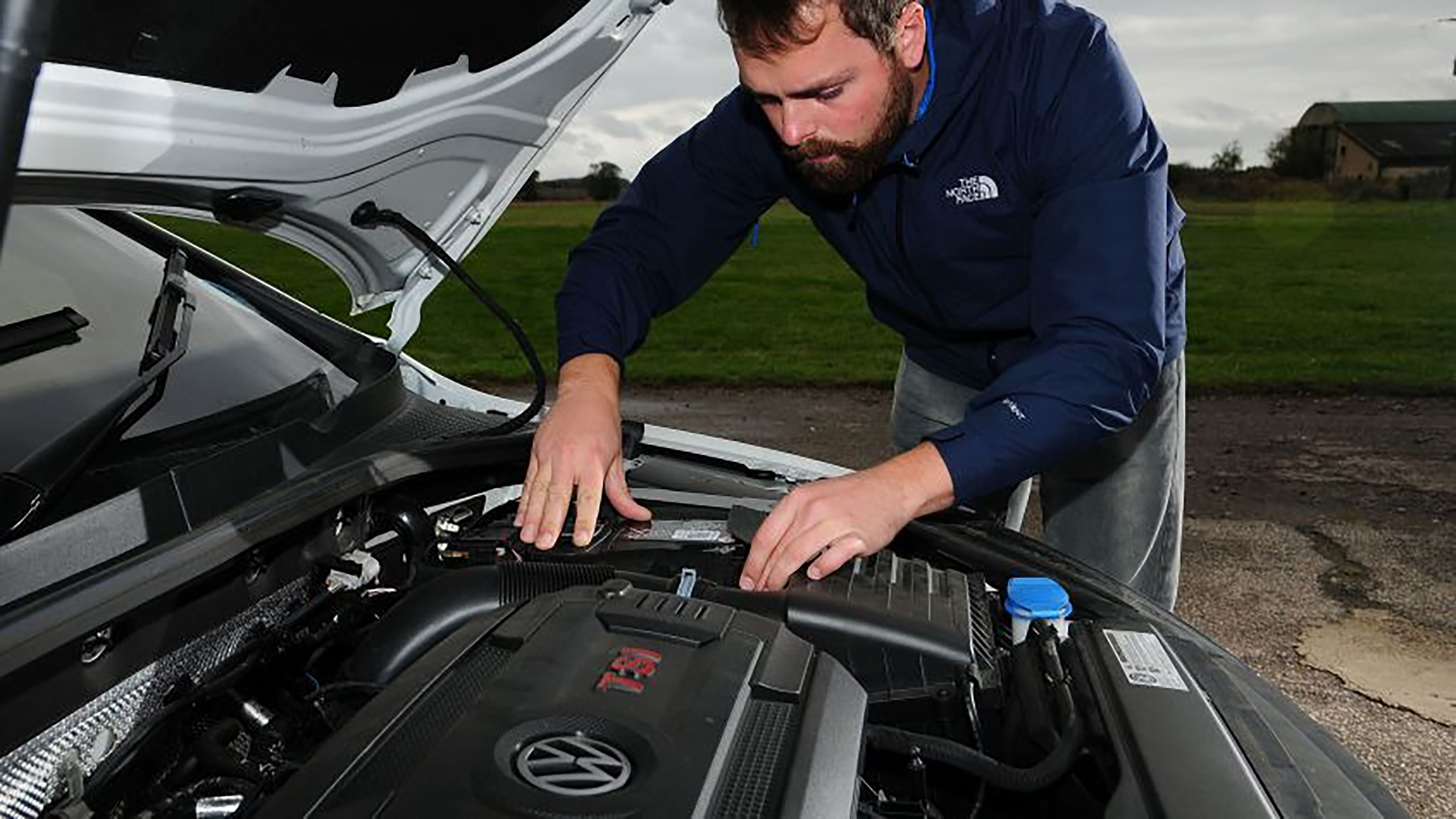 Auto Express photographer Otis Clay changing a car battery