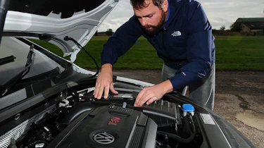 Auto Express photographer Otis Clay changing a car battery