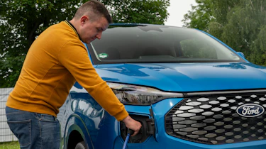 Auto Express senior content editor Shane Wilkinson plugging in the Ford E-Transit Custom