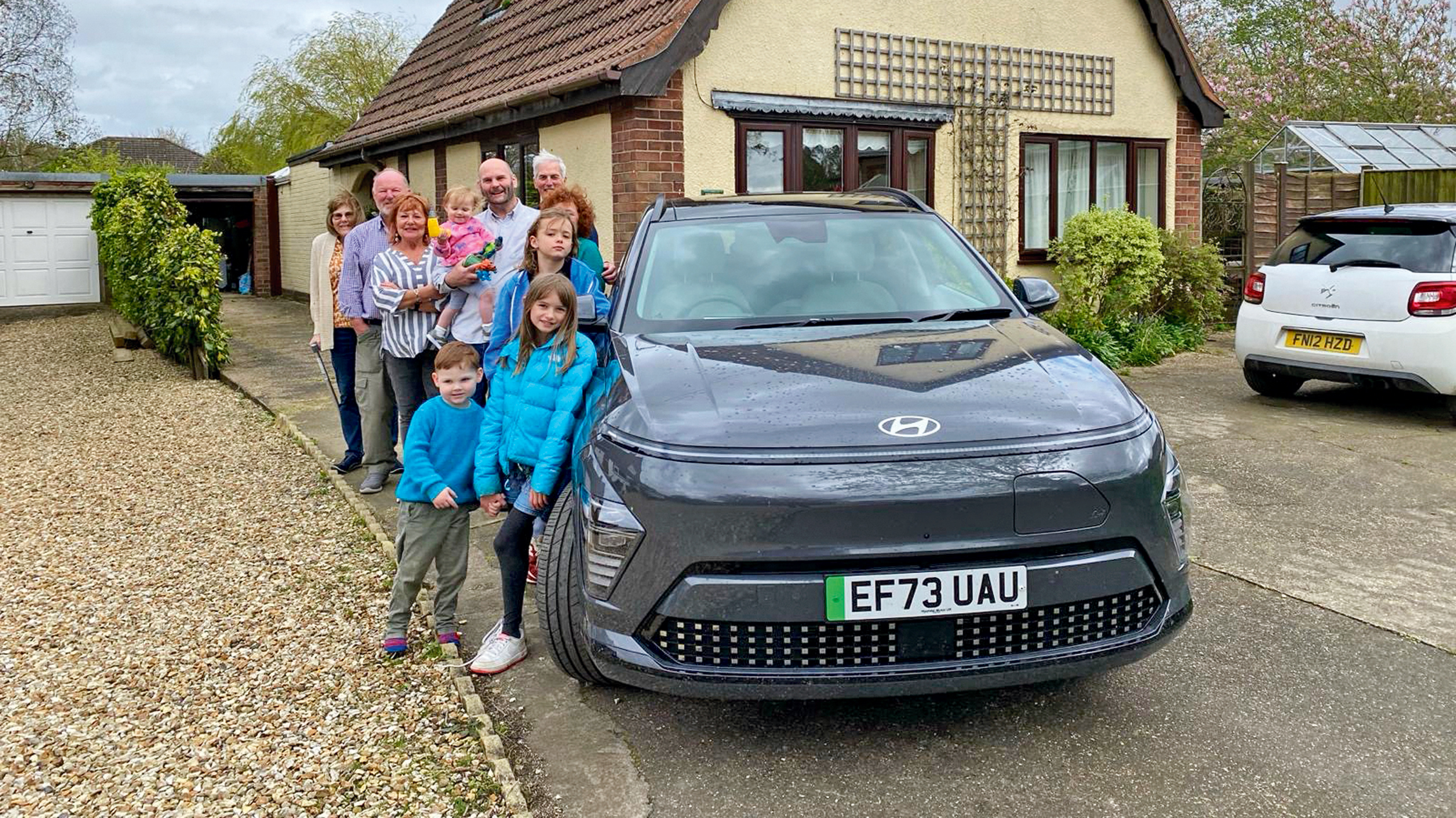 Auto Express creative director Darren Wilson's family standing next to the Hyundai Kona