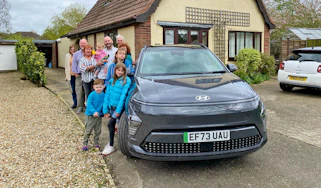 Auto Express creative director Darren Wilson's family standing next to the Hyundai Kona