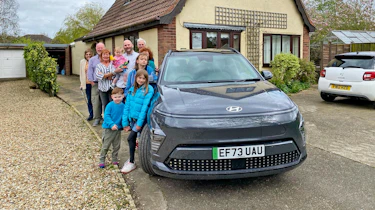 Auto Express creative director Darren Wilson's family standing next to the Hyundai Kona