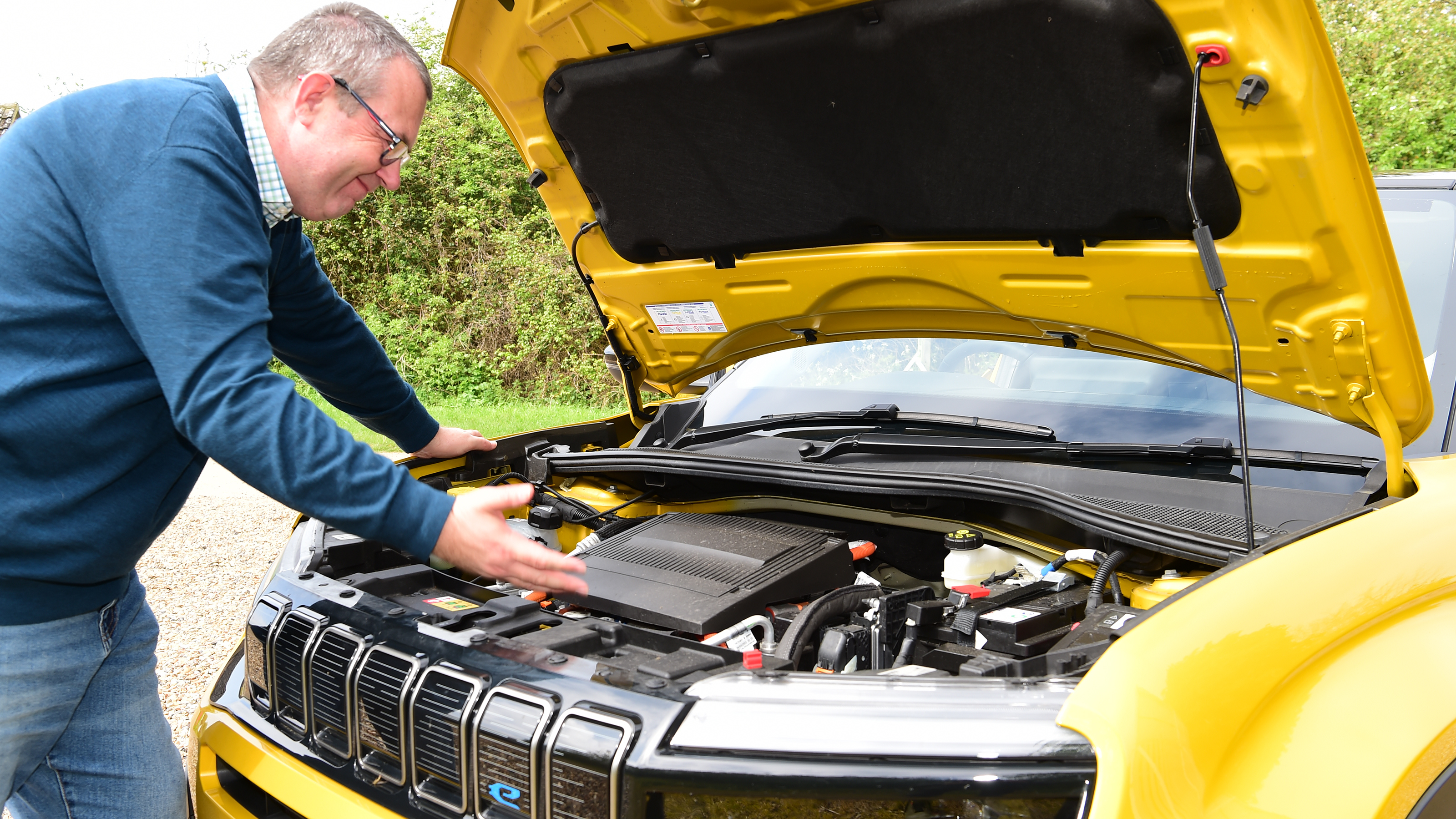 Auto Express editor-at-large John McIlroy inspecting the Jeep Avenger's engine bay