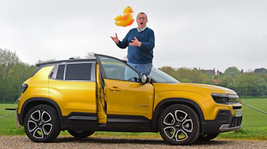 Auto Express editor-at-large John McIlroy standing on the Jeep Avenger's door sill while holding an inflatable duck