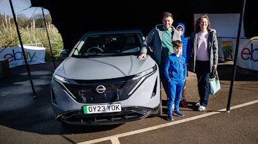Auto Express head of digital content Steve Walker and family standing next to the Nissan Ariya