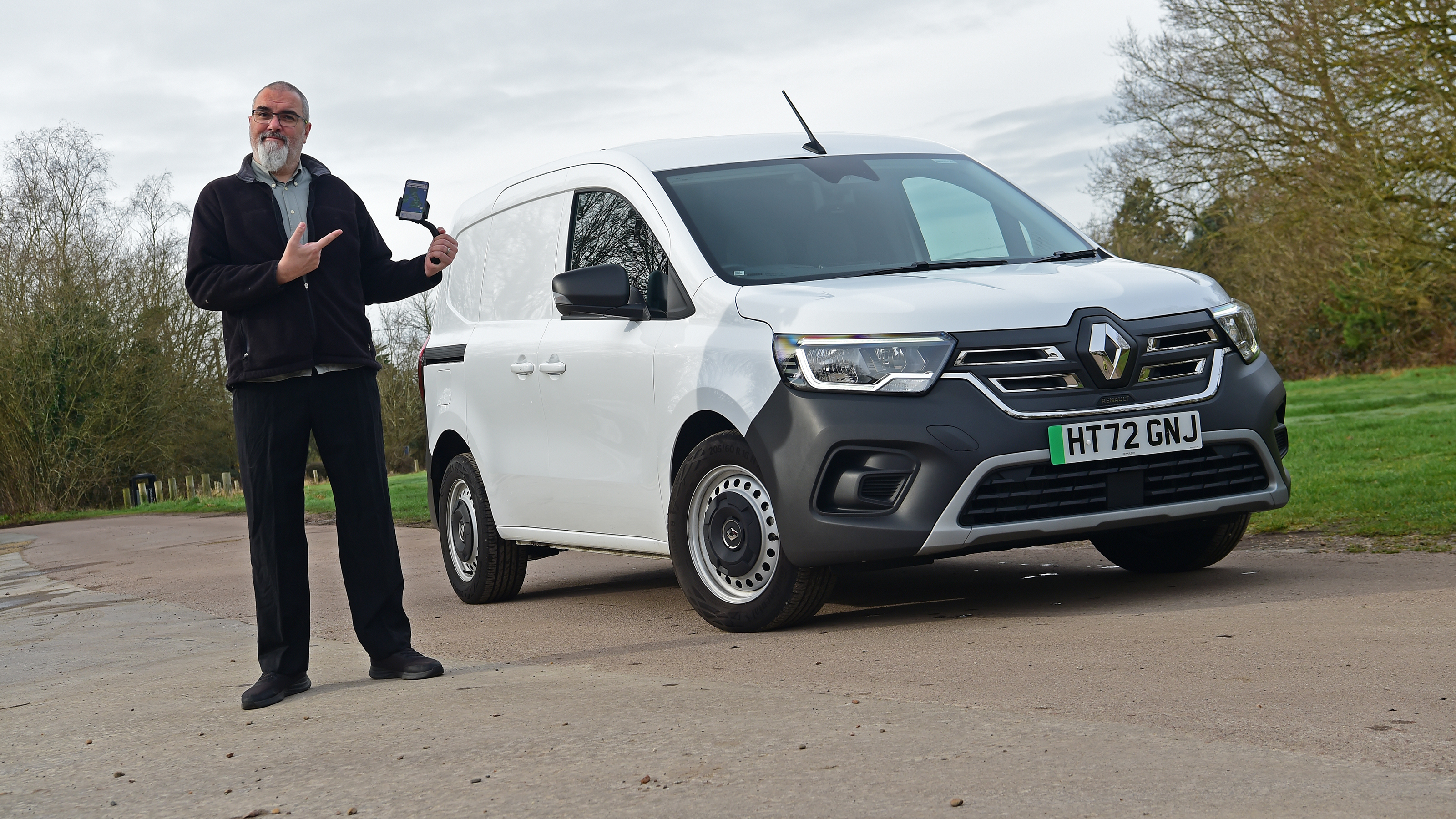 Auto Express senior road test editor Dean Gibson pointing at the Renault Kangoo E-Tech