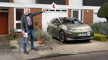 Auto Express chief sub-editor Andy Pringle holding two L-plates while standing next to the Volkswagen ID.3