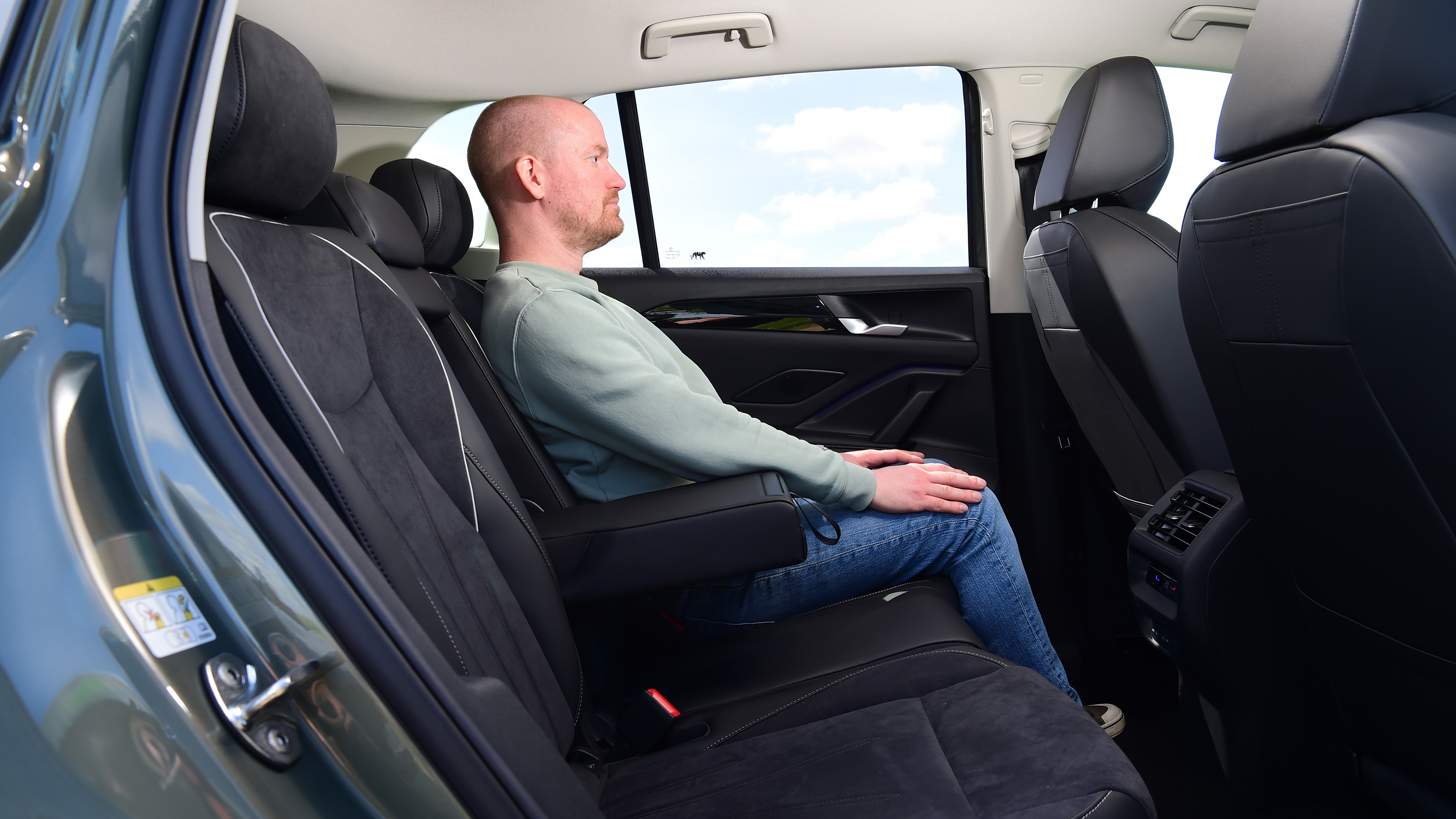 Auto Express chief reviewer Alex Ingram sitting in the Volkswagen Tiguan's back seat
