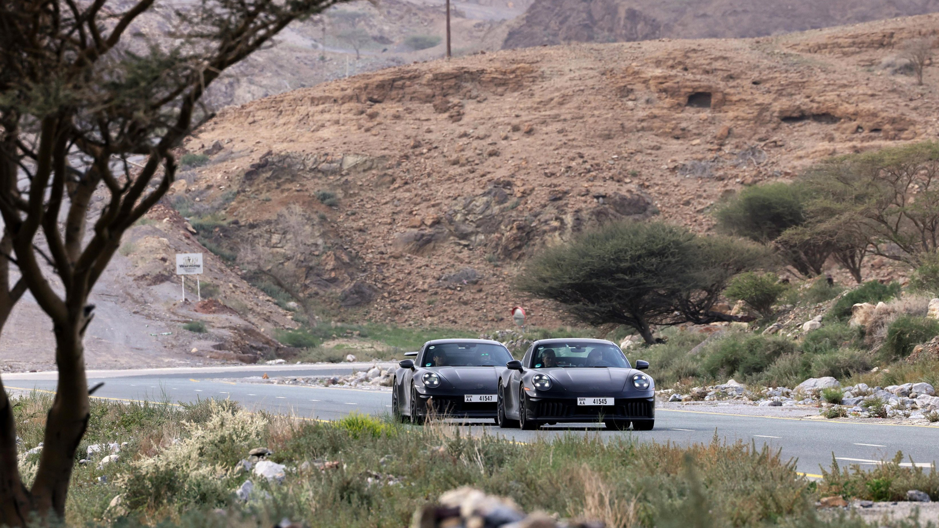 New Porsche 911's front 3/4 on a road
