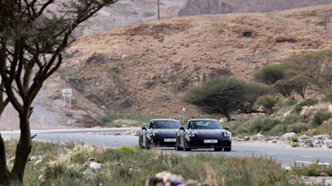 New Porsche 911's front 3/4 on a road