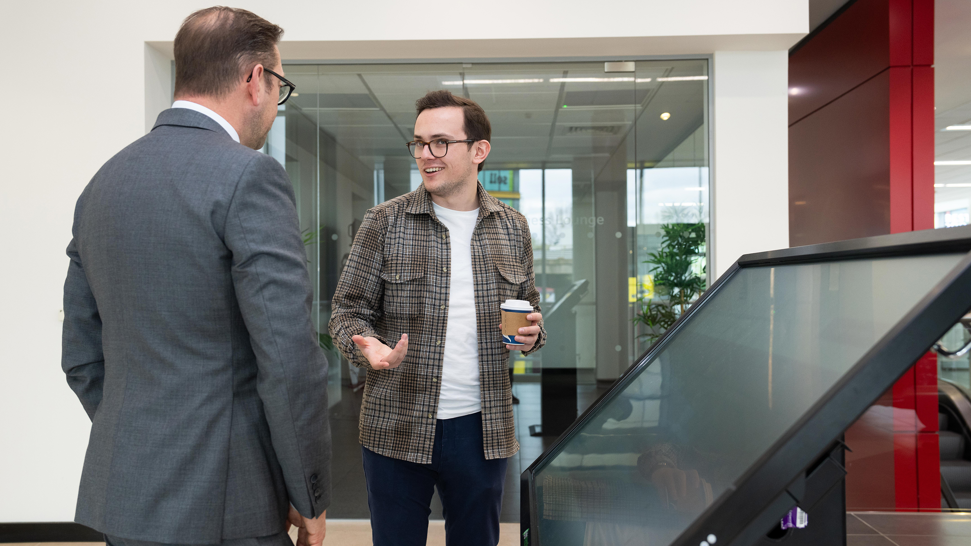 Tom Jervis discussing the rebrand on a touchscreen