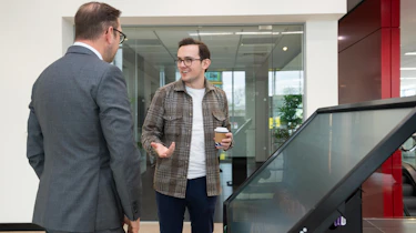 Tom Jervis discussing the rebrand on a touchscreen