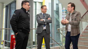 Tom Jervis discussing the rebrand with two of KIA management