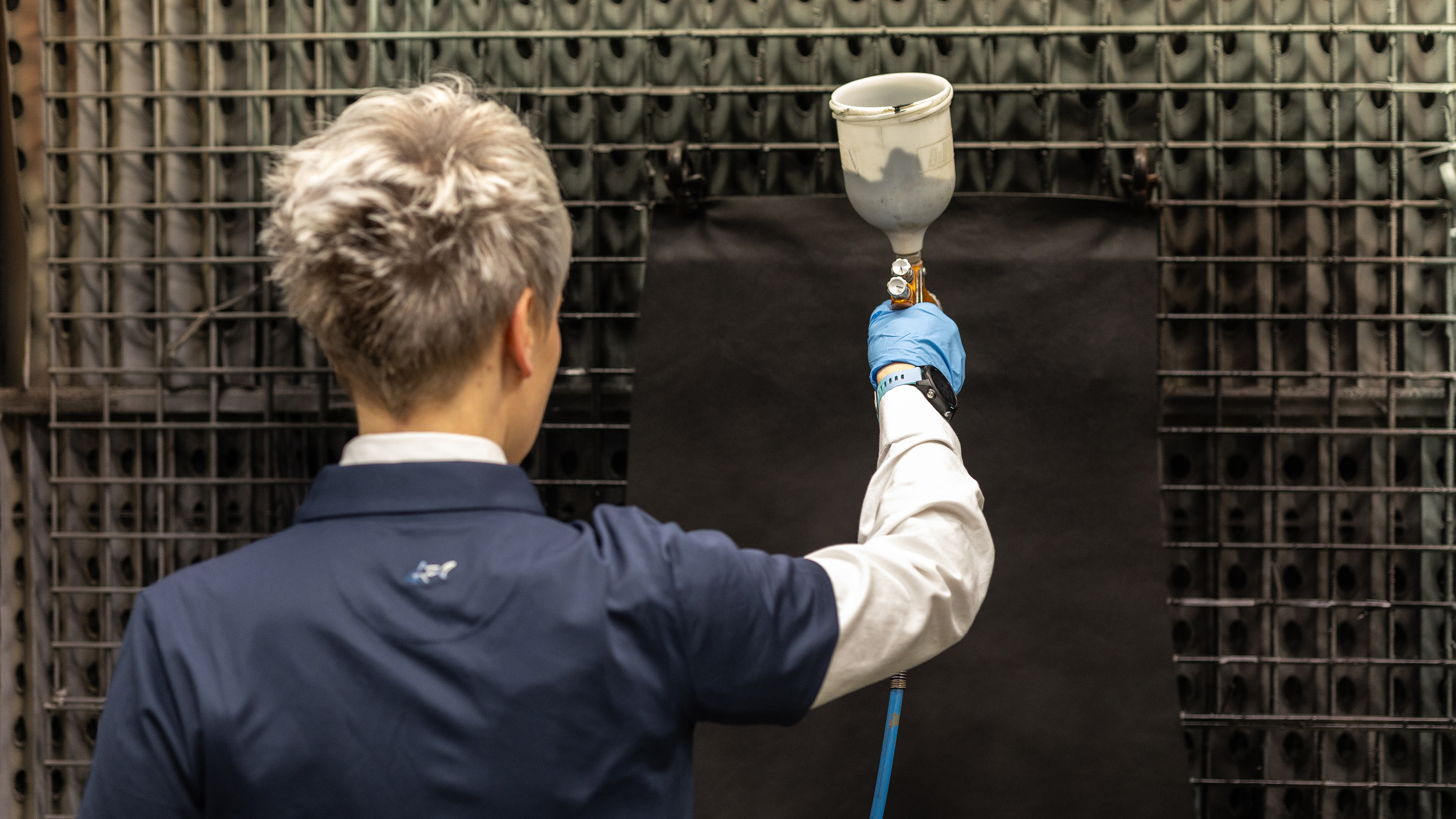 Bridge of Weir technician spraying leather