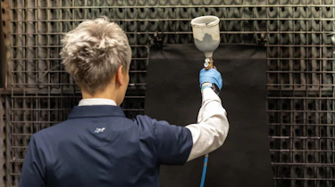 Bridge of Weir technician spraying leather