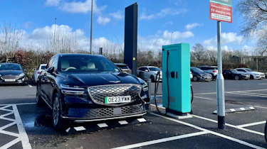 Genesis Electrified GV70 connected to charging station